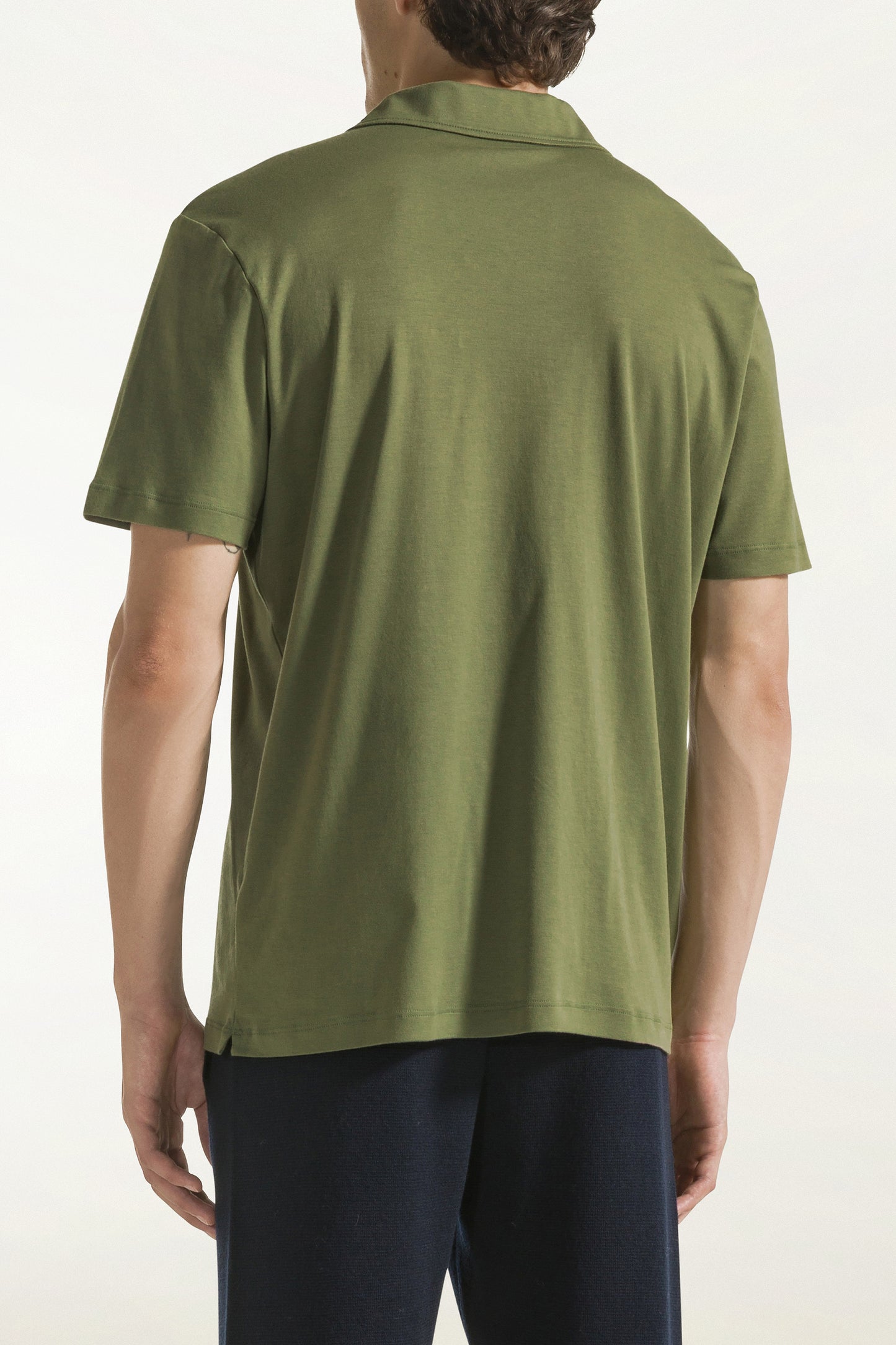 Green short-sleeved buttonless polo shirt